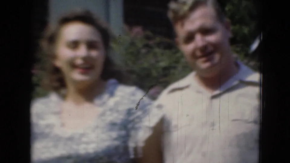 The final frame shows a woman in a patterned dress beside a smiling man in a light shirt, outdoors in Middletown archival home-movie footage.
