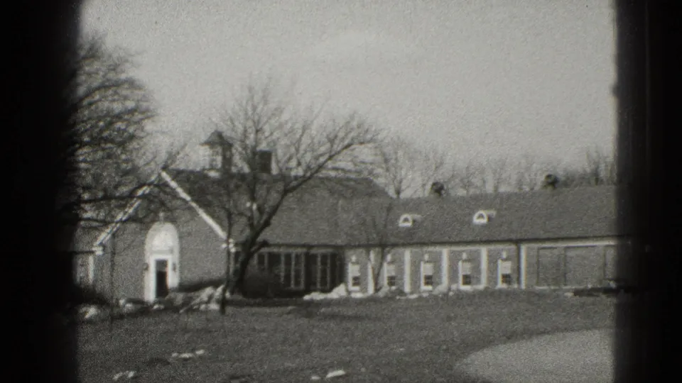 Residential exterior in Middletown, Pennsylvania with arched entry, attached wing, bare tree, lawn, and curved driveway edge.