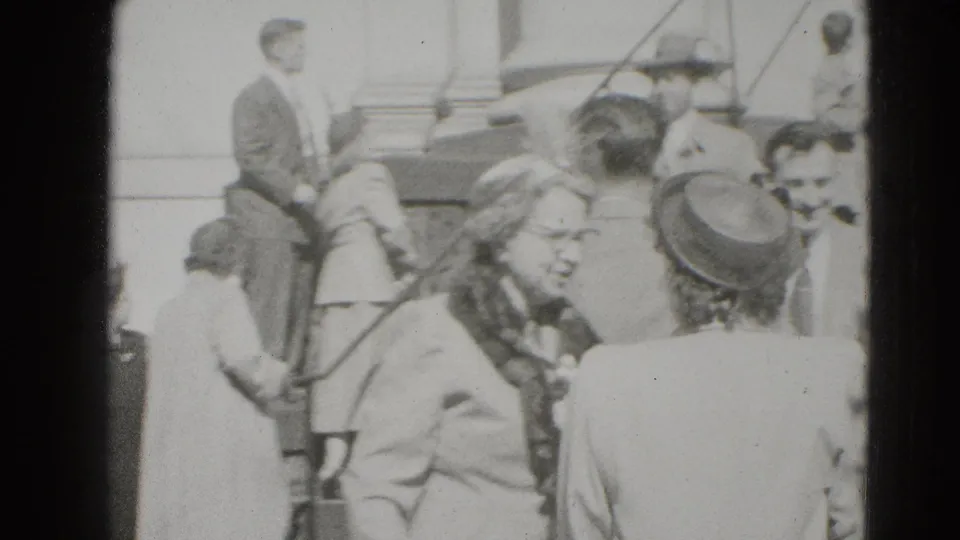 In Middletown, Pennsylvania, guests in coats and hats gather near building steps around a newly married couple.