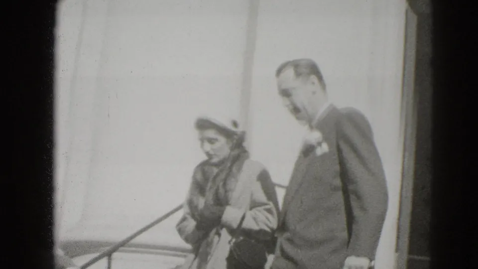 In Middletown, Pennsylvania, a formally dressed woman in a hat and a suited man descend exterior steps in 1947 home-movie footage.