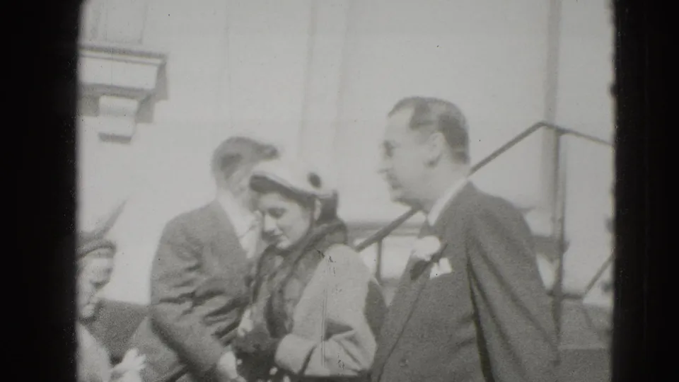 The couple continues down the steps in Middletown, Pennsylvania, with onlookers and a building entrance behind them.