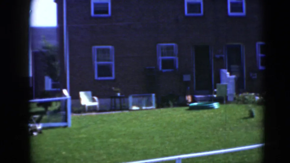 Daylight view of a Middletown, Pennsylvania brick house exterior with lawn furniture, hose, railing, and hula hoop.