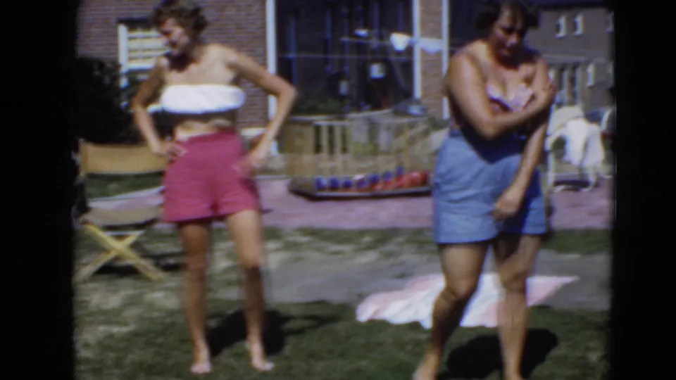 In the final frame, one woman stands with a hand on her hip while the other looks down and adjusts her arm in a sunny residential backyard.