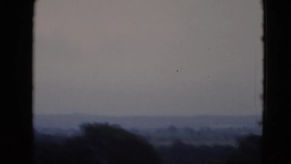 1947 8mm frame near Middletown, Pennsylvania, showing a low rural horizon and dark foreground window framing.