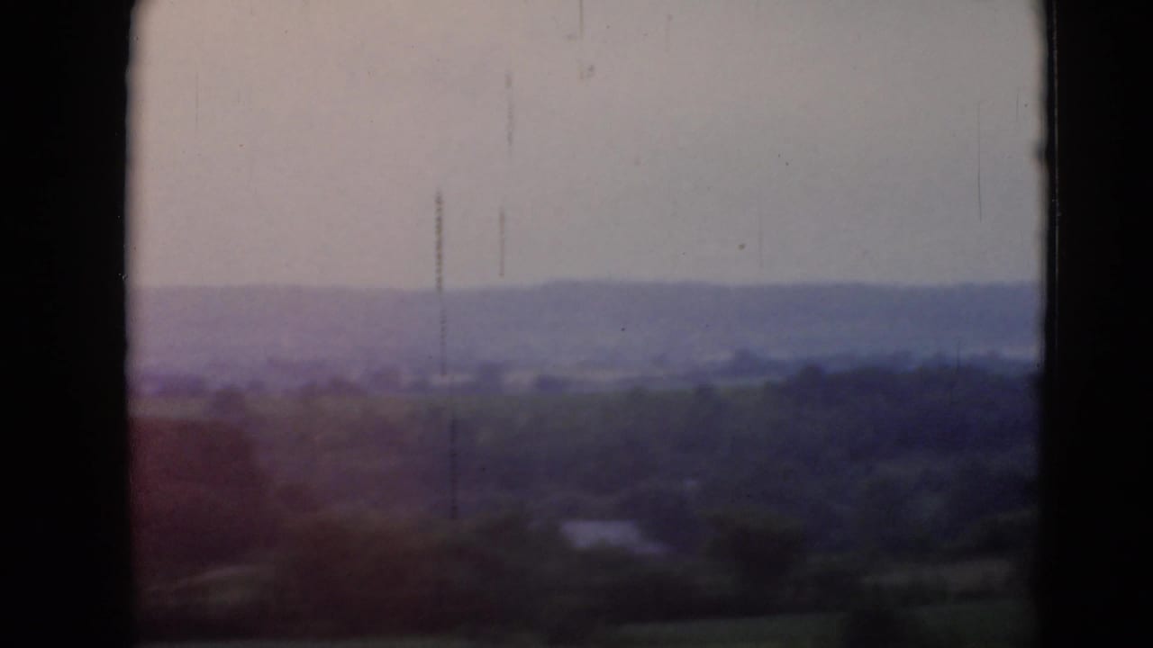 Soft 8mm view of rolling rural landscape near Middletown, Pennsylvania, with dark gate edges and muted color.