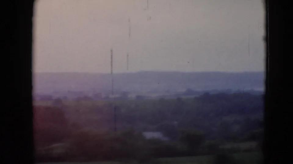 Soft 8mm view of rolling rural landscape near Middletown, Pennsylvania, with dark gate edges and muted color.