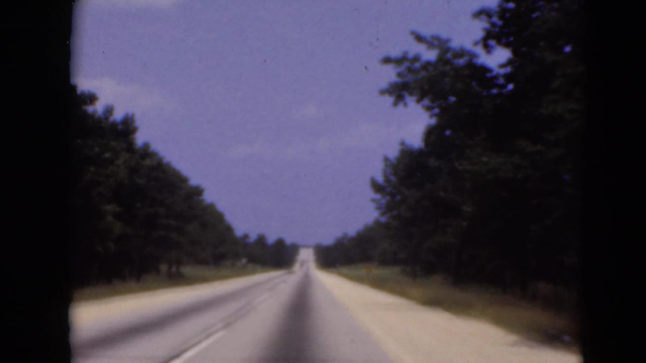 Forward-facing 8mm view of a straight wooded highway in the Middletown, Pennsylvania metadata location.