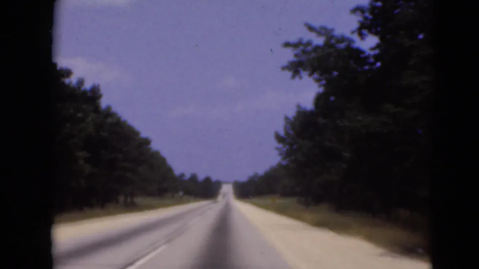 Forward-facing 8mm view of a straight wooded highway in the Middletown, Pennsylvania metadata location.