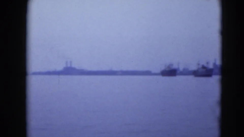 Wide 8mm harbor view in Middletown, Pennsylvania, with boats near the right edge and industrial shapes on the far shore.