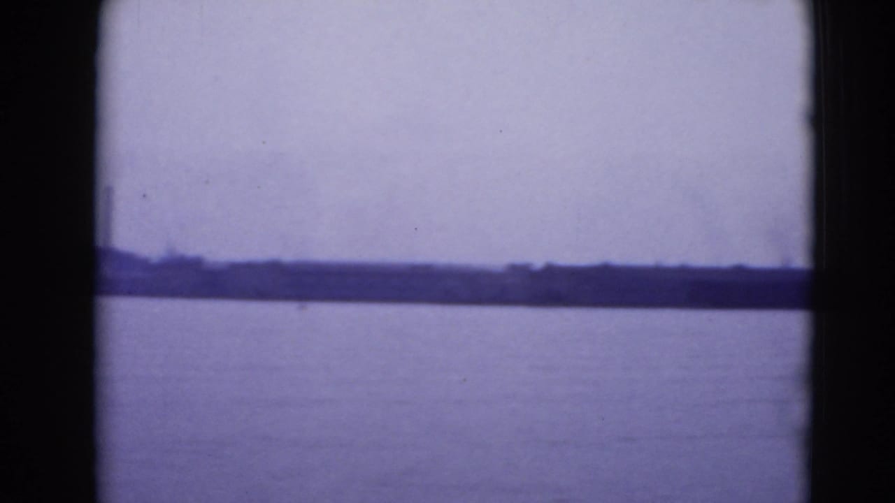 Distant shoreline across open water with dark 8mm frame edges.