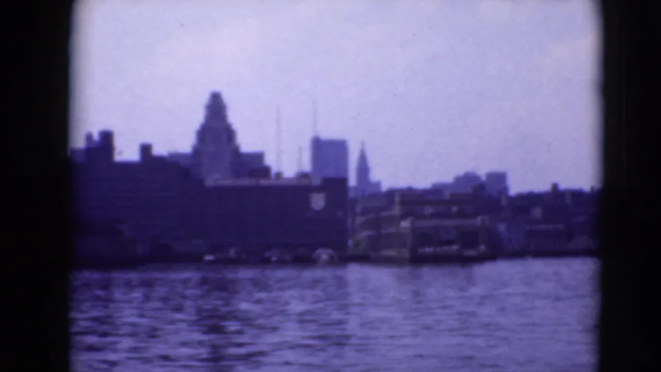 Middletown-area waterfront skyline across water, with a prominent domed or tower-like silhouette and soft 8mm color shift.