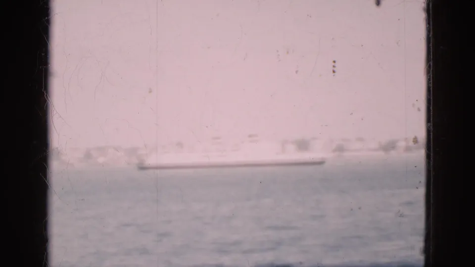 The clip ends on a Denmark harbor view, with a ship, low buildings, and water framed by the window edge.