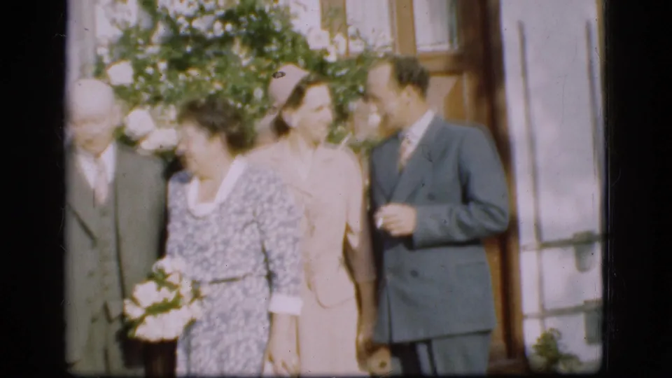 The 1975 Denmark wedding home movie shows a family group outside the house, including an older woman holding flowers and adults in formal dress.