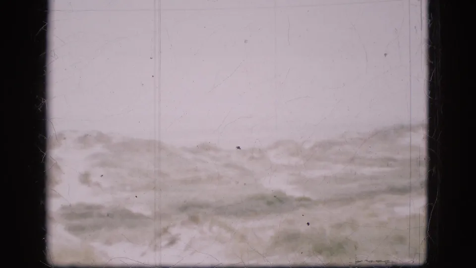Snowy ridges and empty ground fill the frame in this 1975 Danish 8mm landscape view.