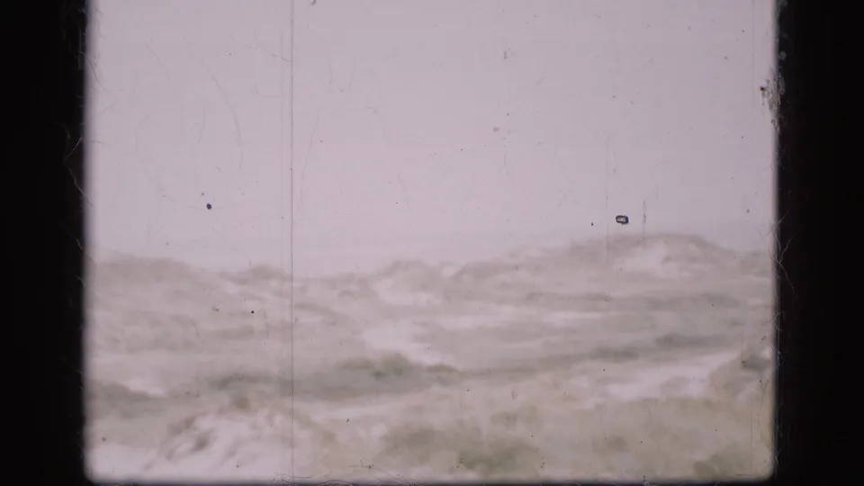 A quiet Danish winter landscape appears through soft exposure, grain, and visible 8mm film wear.