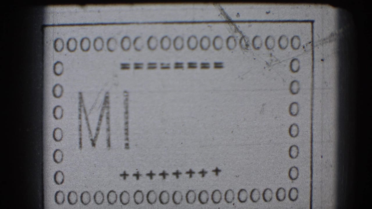 8mm leader frame with the letters MI inside a bordered film strip.