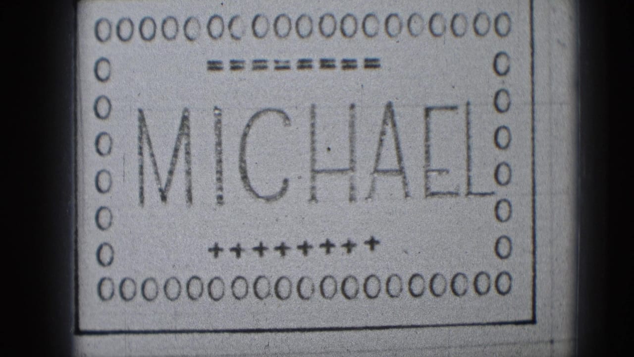 Late-1940s 8mm title card showing MICHAEL in large letters with punched-film-style decoration and soft scan edges.