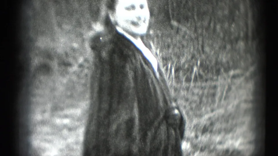A woman in a dark fur coat smiles toward the camera in a soft-focus 1948 home-movie frame from Middletown, Pennsylvania.