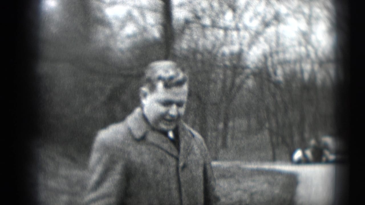 Man in a wool overcoat and tie walks outdoors in Middletown, Pennsylvania, in 1948 home-movie footage.