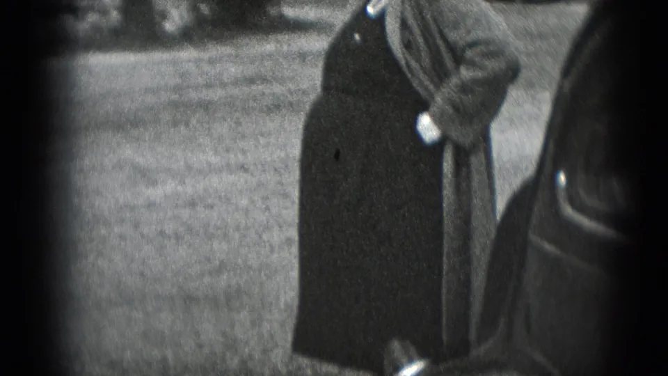 In 1948 Middletown, Pennsylvania footage, a smiling pregnant woman stands near a rounded automobile on a lawn.
