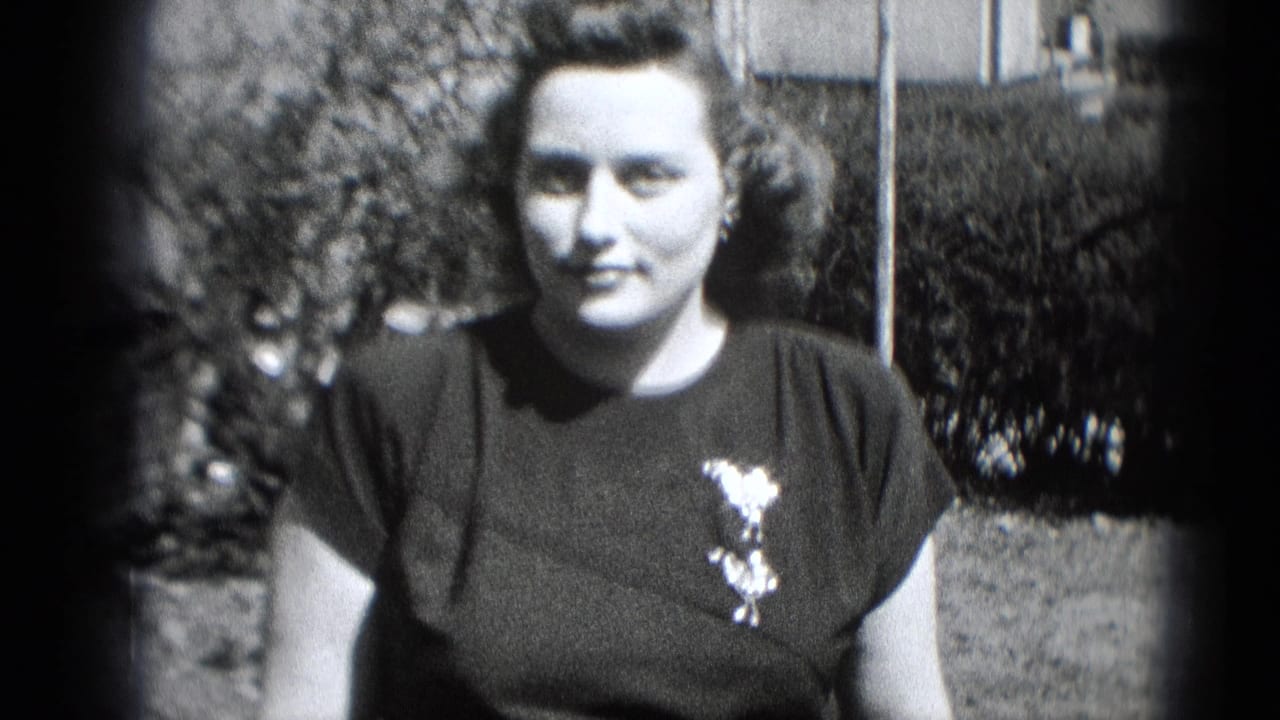 A dressed-up woman faces the camera outdoors in Middletown, Pennsylvania, with styled hair and a brooch on her dark dress.