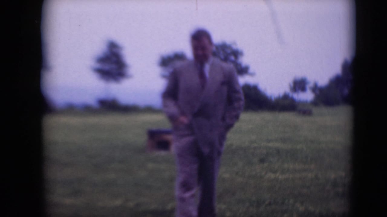 In Middletown, Pennsylvania home-movie footage from 1948, a man in a suit approaches through grass with trees behind him.
