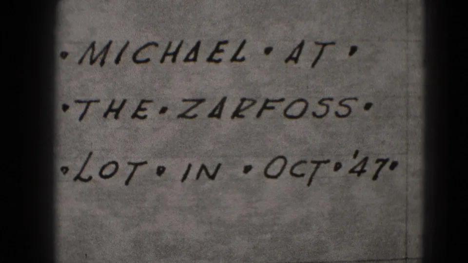 Repeated close-up of the handwritten Zarfoss lot note, with soft focus, grain, and the Oct '47 date visible.