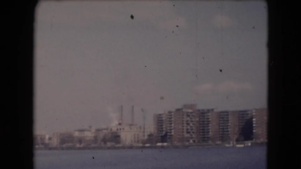 Reported Middletown waterfront panorama showing distant shoreline buildings, apartment blocks, smokestacks, haze, and 8mm dust marks.