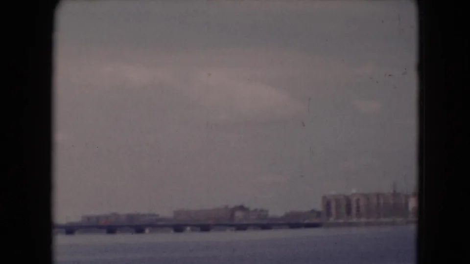 1940s 8mm view near Middletown, Pennsylvania, showing a long bridge across a wide river with buildings on the far shore.