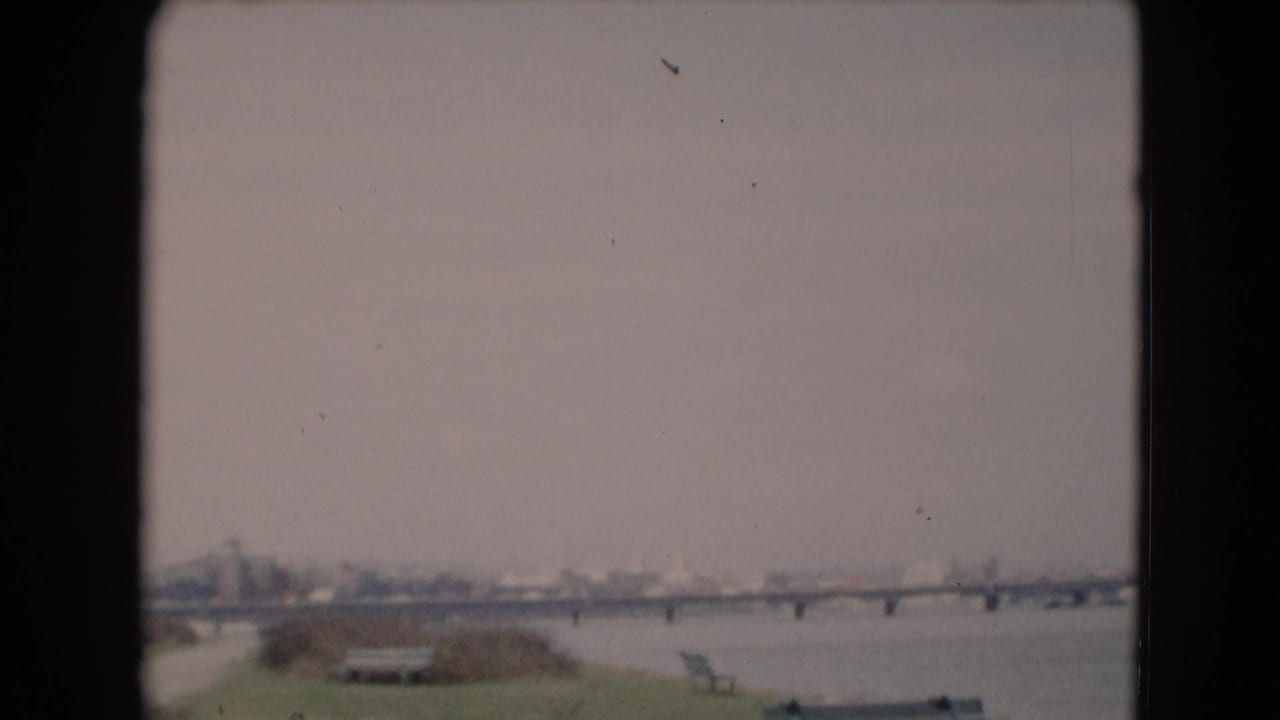 Wide 8mm frame showing the river bridge and distant shoreline near Middletown, Pennsylvania, with muted color and soft focus.