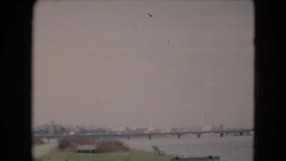 Wide 8mm frame showing the river bridge and distant shoreline near Middletown, Pennsylvania, with muted color and soft focus.
