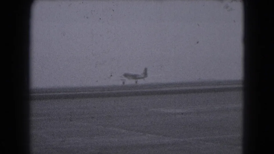 Small propeller airplane seen on a runway in Middletown, Pennsylvania, in 1975-era 8mm home-movie footage.