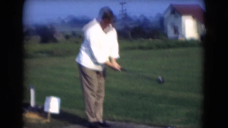 In the final frame, the Middletown golfer bends through his swing while the 8mm camera holds a wide view of the course area.