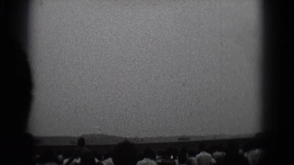 1975 Middletown, Pennsylvania frame with spectators silhouetted along the bottom edge under a bright sky and low horizon.