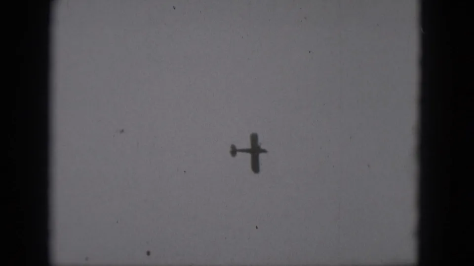 The aircraft is seen farther across the pale sky, silhouetted within the 8mm frame from the Middletown, Pennsylvania clip.