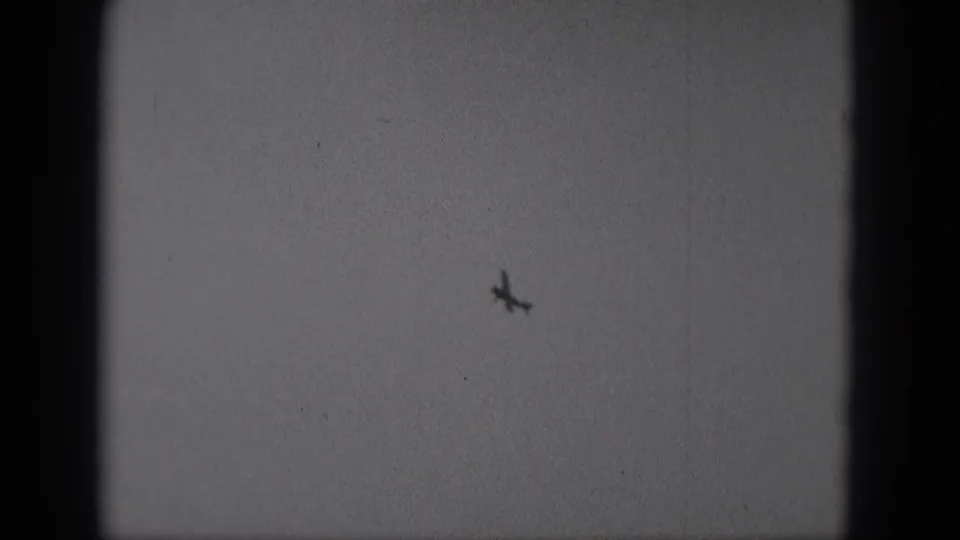 The distant airplane appears angled in the sky near the end of the 1975 Middletown home-movie clip.