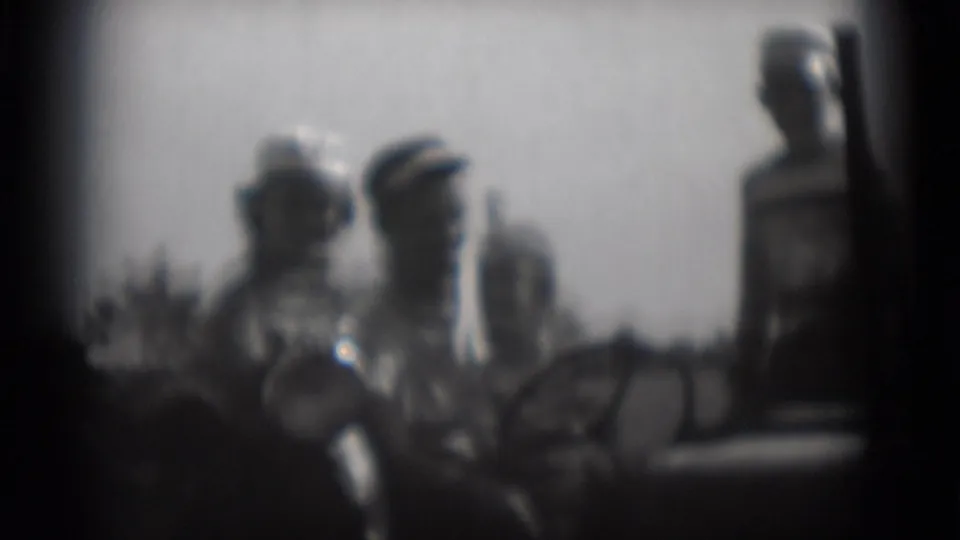 Middletown, Pennsylvania 8mm frame with two central adults and a standing right-side figure in a soft outdoor family gathering.