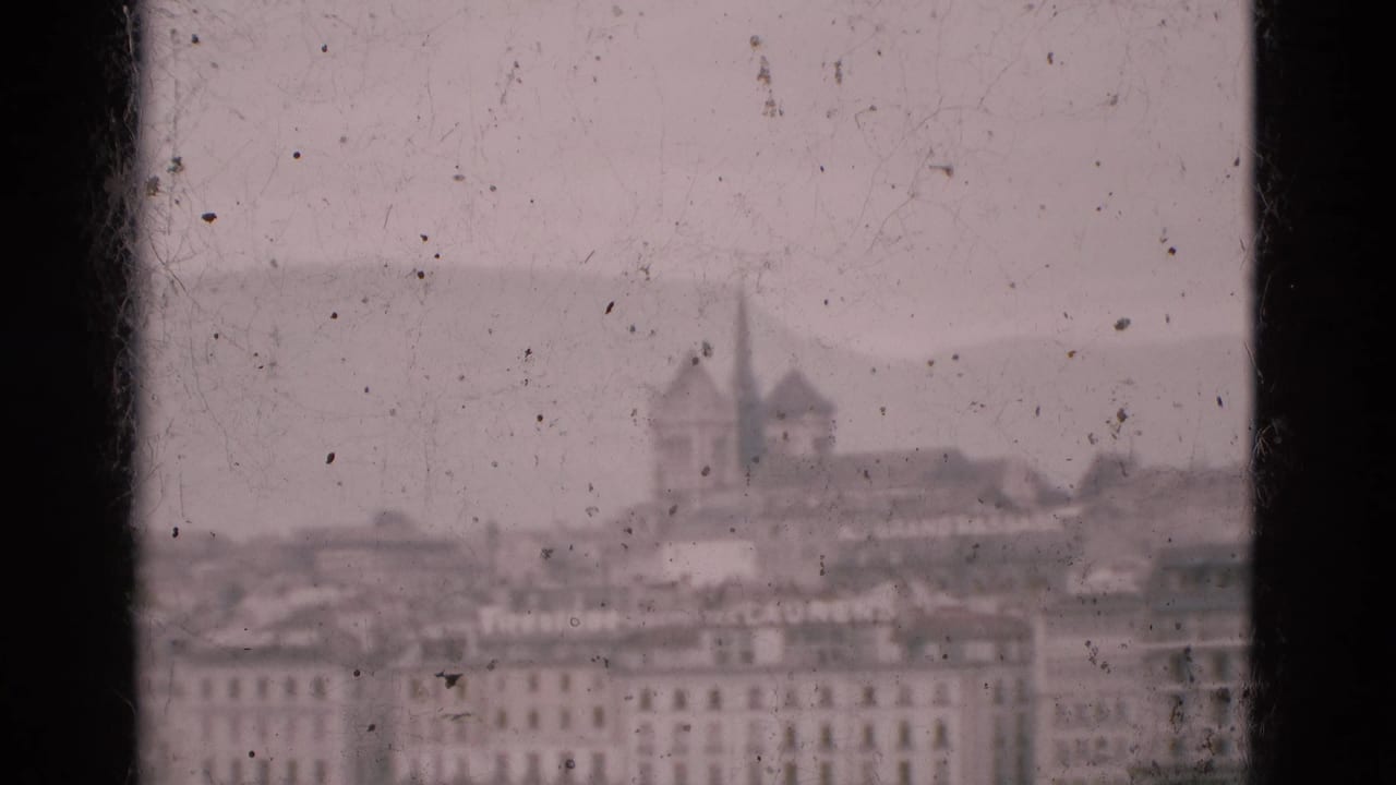 Hazy waterfront city view through dusty window glass with dark vertical frame edges.