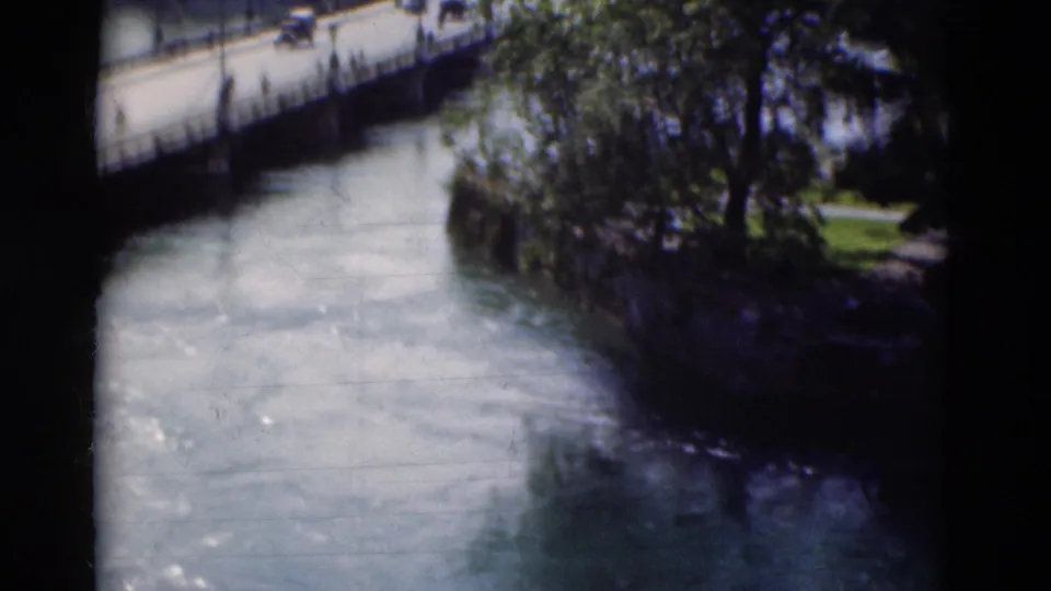 Portugal 1975 8mm frame with the river and part of the bridge visible through a dark edge of the film scan.