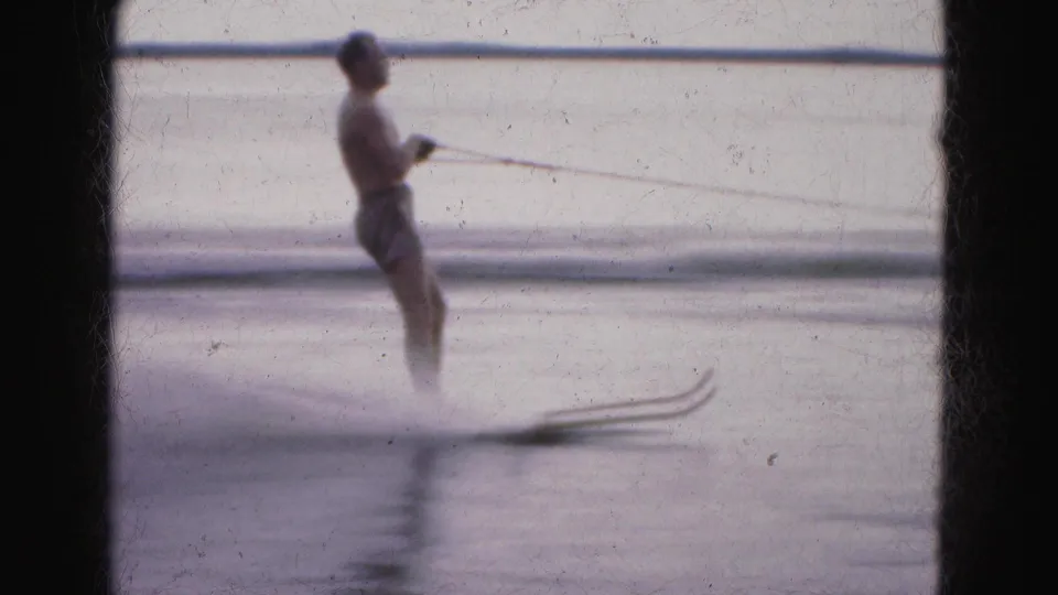 A man water skis on a calm Florida Everglades lake in 1975, holding a tow rope with no visible life vest.