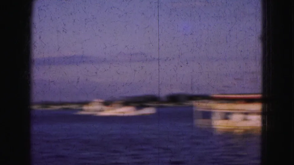 1975 Florida Everglades waterway view with a small white vessel in the center and part of a larger boat cropped at right.