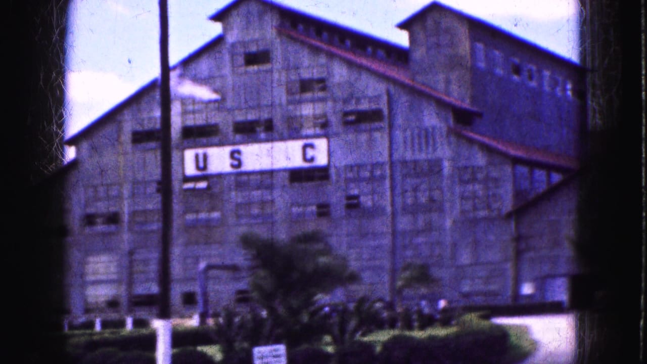 Similar view of the industrial building with USC sign and landscaped entrance.