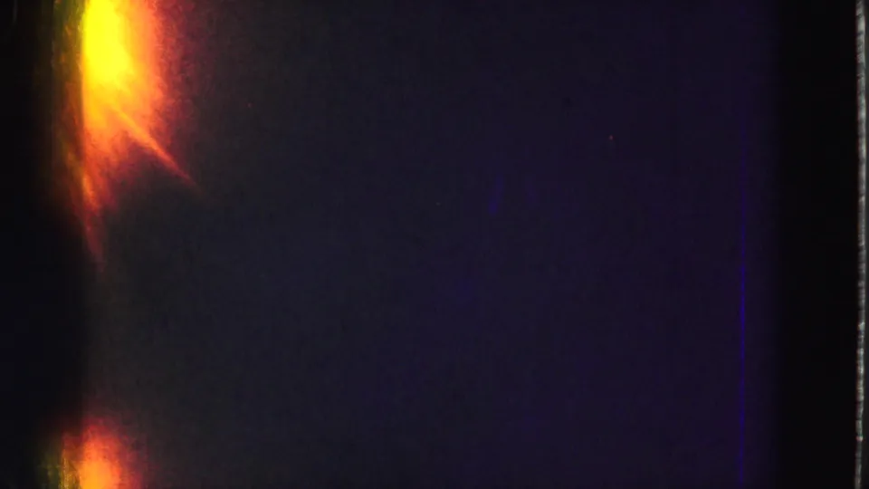 8mm home-movie frame dominated by a warm light leak and dark exposure before the Everglades view clears.