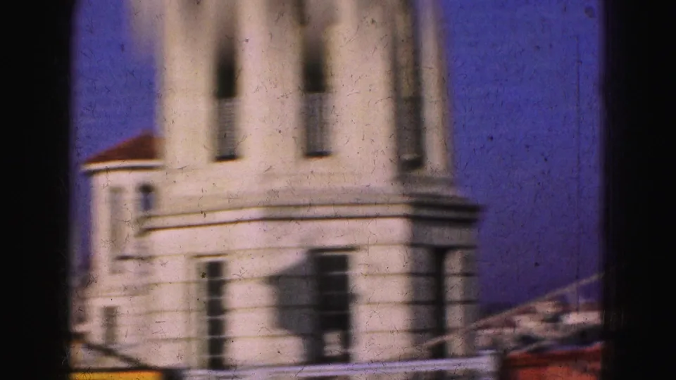 Soft 8mm frame from a 1975 Florida travel clip showing a pale tower-like bridge structure seen from a moving vehicle.