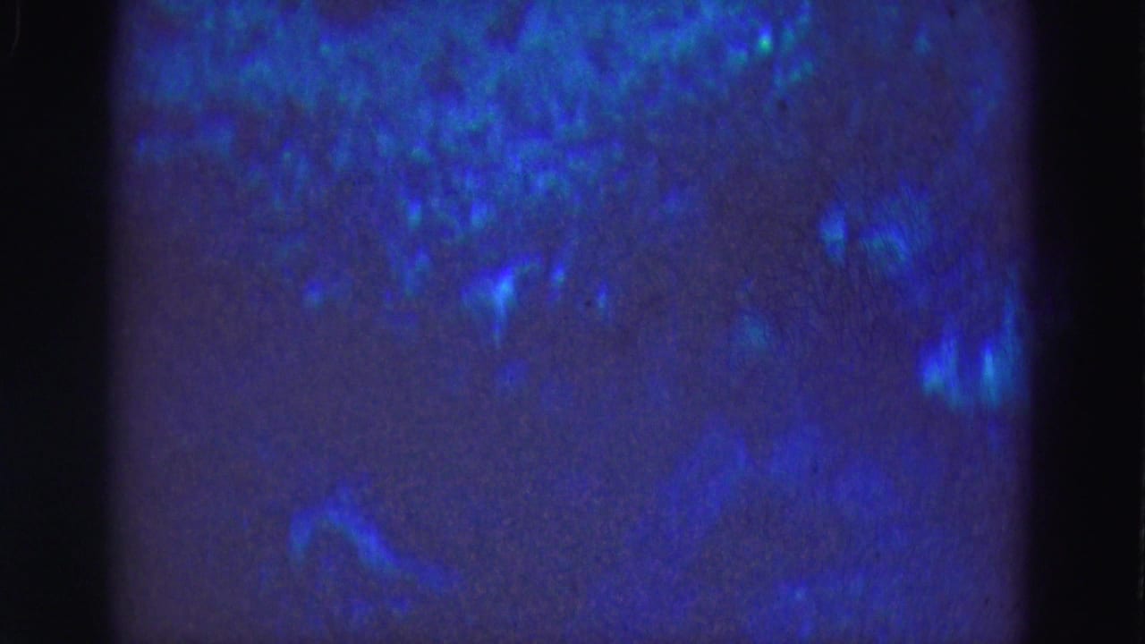 Blue underwater texture with faint turquoise light patches and dark vertical frame edges.
