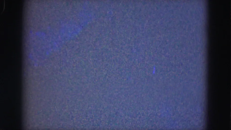 1975 Florida Everglades underwater frame with faint blue aquatic traces and pronounced 8mm grain.