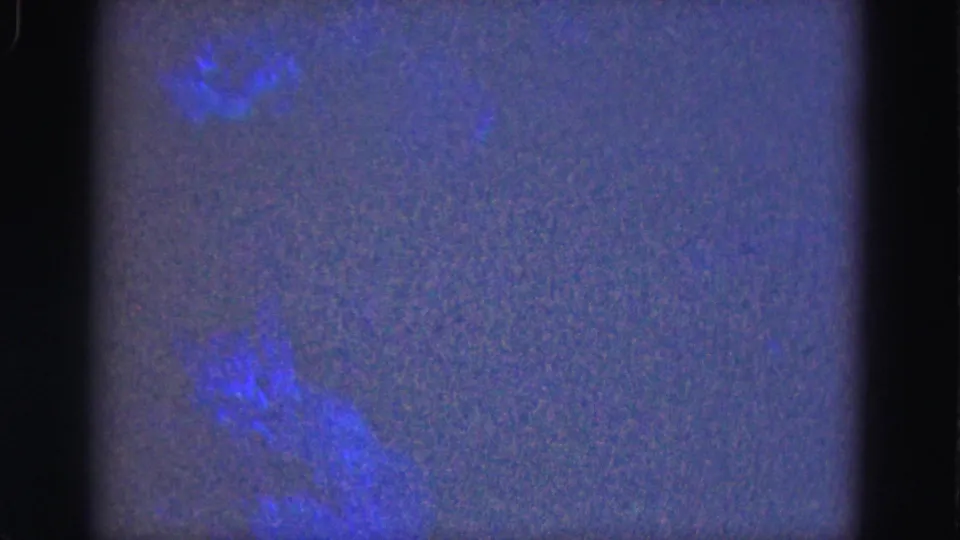 1975 Florida Everglades frame with blue cloud-like exposure areas, purple darkness and visible 8mm contact-sheet borders.