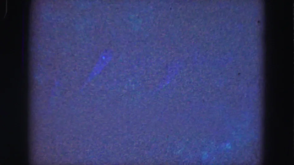 1975 Florida Everglades 8mm underwater footage showing mostly murky blue water, faint green glow, grain, and dark frame borders.