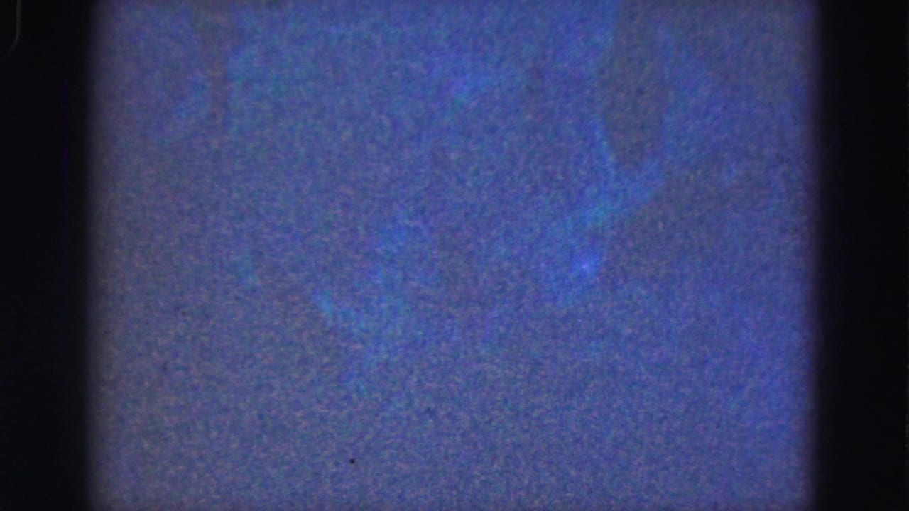 Soft blue underwater frame with faint texture and dark film borders.