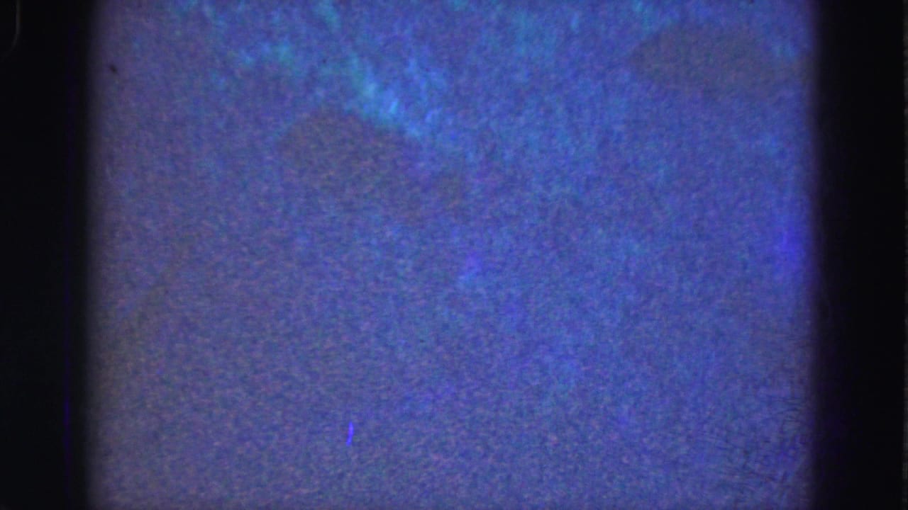 Blue-tinted soft frame with dark film edges, grain, and diffuse underwater-looking texture.